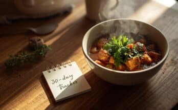 how fast does the aip diet work — AIP-friendly stew and progress tracker on a kitchen table.